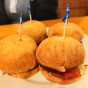 a plate of mini sandwiches