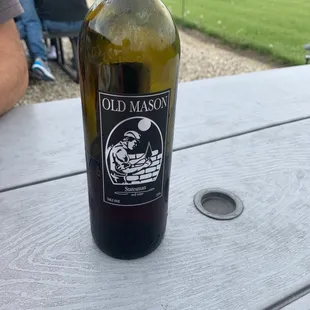 a bottle of wine on a picnic table