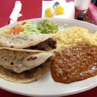 Two fajita tacos, rice and beans