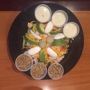 Chef salad with avocado slices , flower seed , ranch dressing