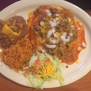 Red Enchilada plate with meat , rice , refried beans , onions, salad