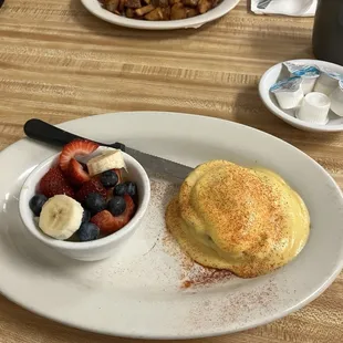 Half order of eggs Benedict with dress fruit