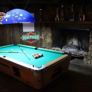 a pool table and a fireplace