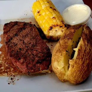 steak, potatoes, and corn on the cob