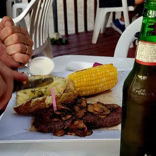 a plate of food and a bottle of beer