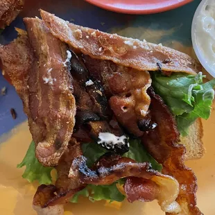 Bacon on 1/2 of BLT sandwich.