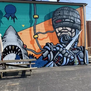 a man in a gas mask and a shark with a knife
