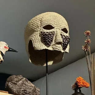 a hat and a bird on a shelf