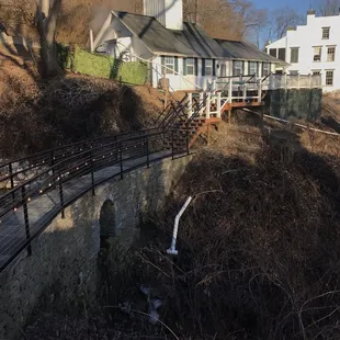 A view of the historic family home, distilling house, and the magnificent dry stack limestone dam.