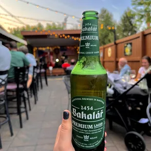 a person holding a bottle of beer