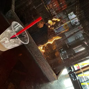 a drink in a plastic cup with a straw