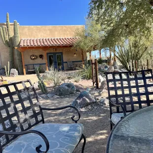 a patio with chairs and tables
