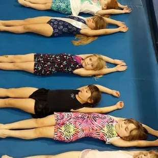 Practicing straight body positions in class.