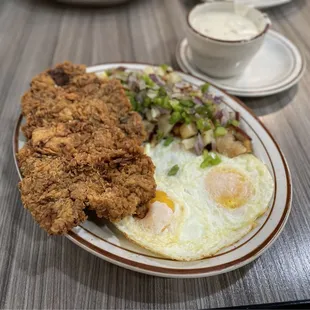 Chicken, Chicken Fried Steak &amp; Eggs with country potatoes and added-on bell peppers and onions