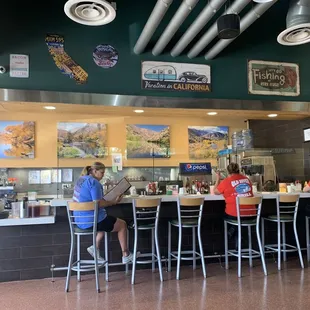 Workers and others enjoy  a well-earned meal at the cool counter
