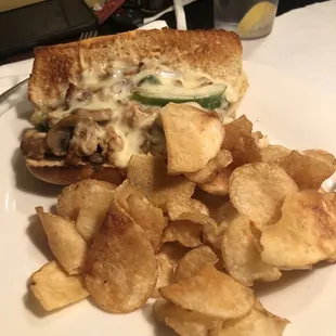 Cheesesteak sub sandwich and chips