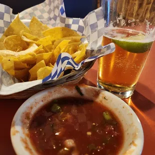 Lightly salted chips with chunky flavorful salsa and a 2 for 1 Happy Hour draft beer.