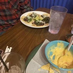 Beef tacos and yellow cheese dip.
