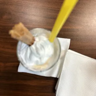 a spoon sticking out of a jar of whipped cream