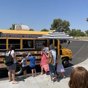 a group of people standing in front of it
