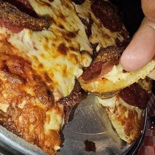 The crust on the medium pizza and the oiliness and the lack of doneness
