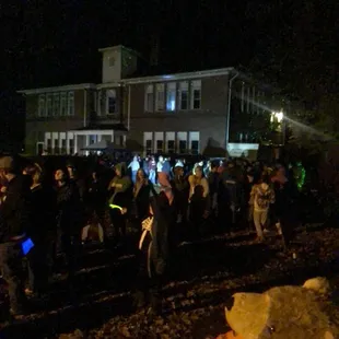 a crowd of people standing on a train track
