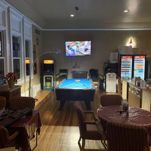 a billiards table in the middle of the room