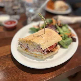 a plate with a sandwich and salad