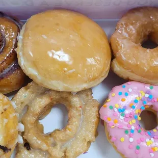 6 donuts- mini cinnamon roll, Holland cream, glazed, old fashioned chocolate drizzle, old fashioned birthday cake, strawberry frosted glazed
