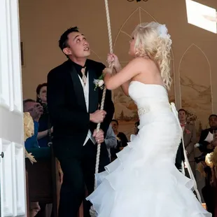The bride and groom ring the bell after the ceremony.