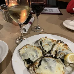 a plate of oysters and a glass of wine