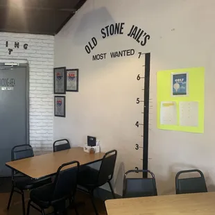 Mug shot wall with a couple of the typical table in the bar.