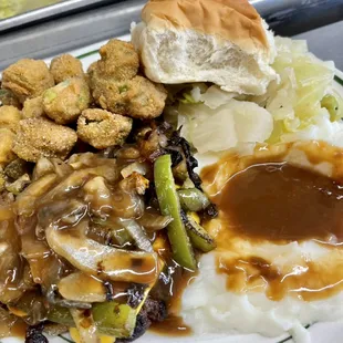 Hamburger steak w/ peppers, onions, cheese, &amp; gravy