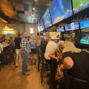 a large group of people watching televisions
