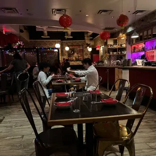 people sitting at tables in a restaurant