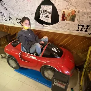 a young boy in a toy car