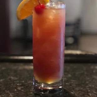 a drink with a cherry garnish