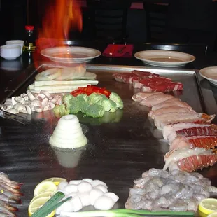 a grill with various types of meat and vegetables