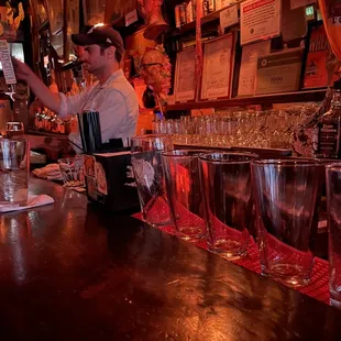 a bartender pouring a drink