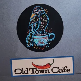 a bird sitting on a cup of coffee