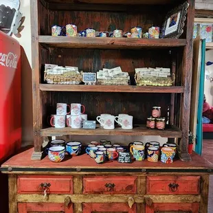 a wooden hutch with many items on it