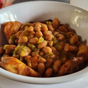 Chile relleno pair topped by whole beans.