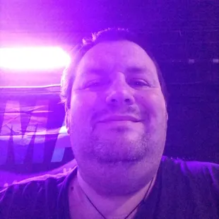 a man in a black shirt smiling