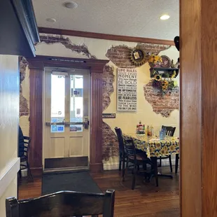Viewpoint of front door from my table. Shows some of the wall decor and the cheerful tablecloths.