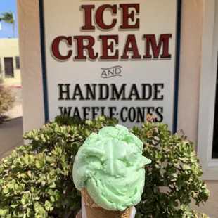 a hand holding an ice cream cone