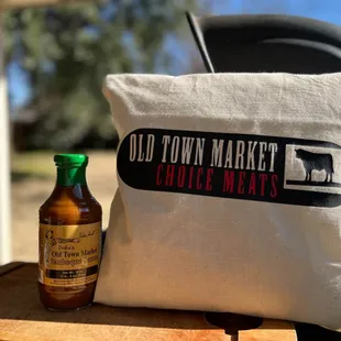 a bottle of hot sauce next to a pillow