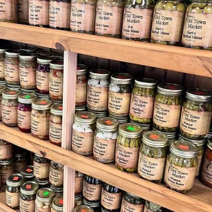 a shelf full of jars of pickles