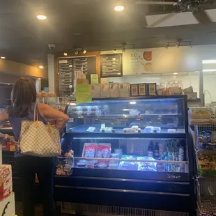 a woman standing in front of a display case