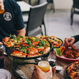 people eating pizza and drinking beer
