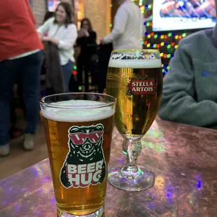 two glasses of beer on a table